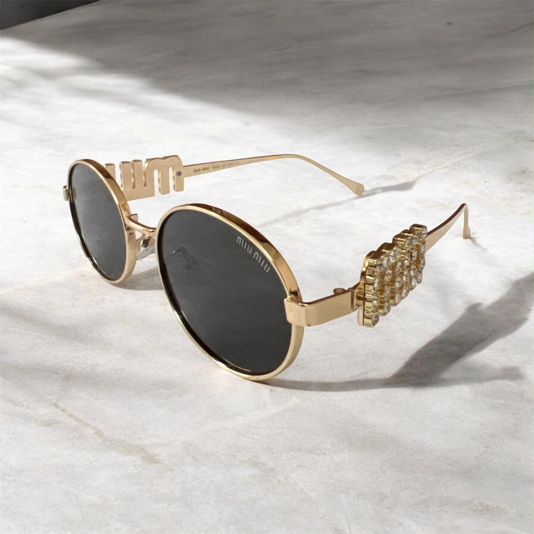 Lunettes de Soleil Ovales Dorées à Verres Noirs